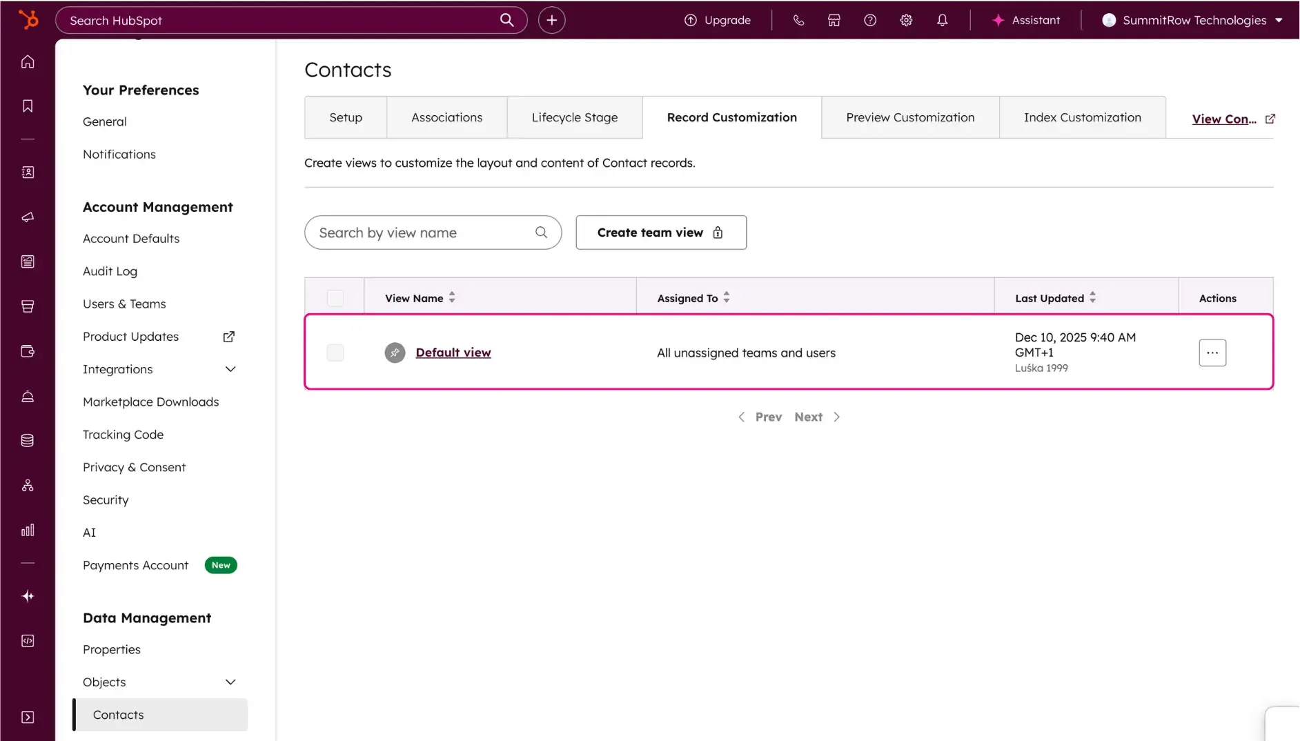 The HubSpot Record Customization list view. The Default view row is highlighted in a pink box, showing where to click to edit the standard layout for all unassigned teams and users.